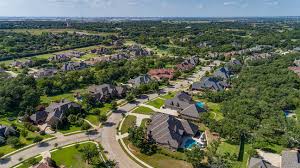 Aerial view of a Keller, TX neighborhood with lush lawns and professional landscaping, highlighting expert landscape installation services by Goat Kings Landscaping.